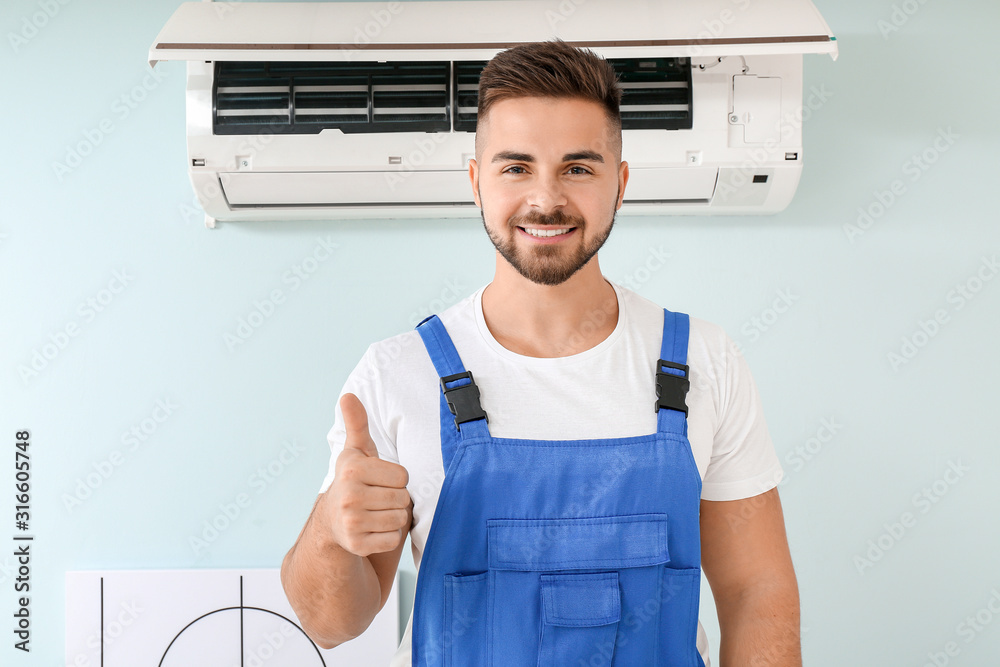 Sticker male technician showing thumb-up after repairing air conditioner