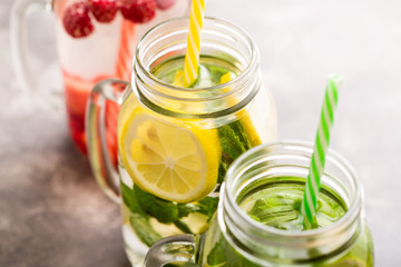 Detox water in jars with raspberries, lemon, lime and mint.