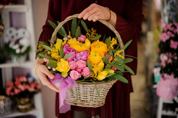 Close shot of peonies and roses in basket