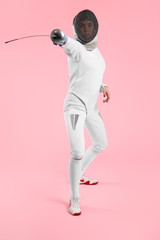 Young female fencer on color background