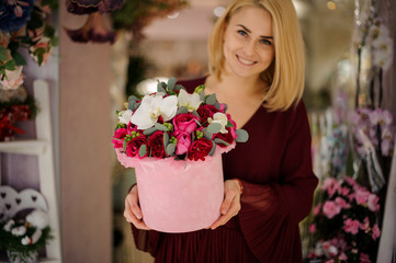 Lovely girl posing with box full of flowers