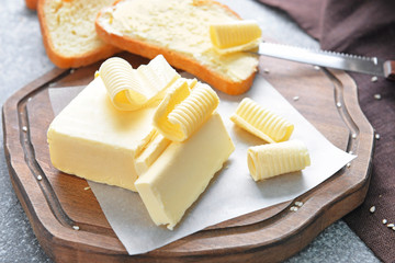 Fresh butter with bread on board