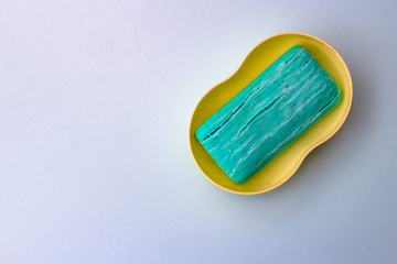 blue dry toilet soap with cracks on a white background