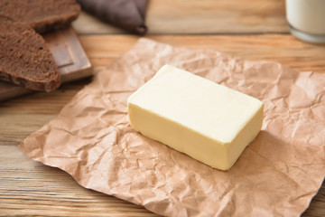 Parchment with fresh butter on table