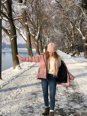 Teenage girl in park, Winter background, River view