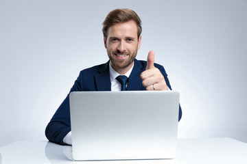 Positive businessman giving a thumbs up