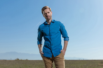 casual man standing with hands in pocket relaxed