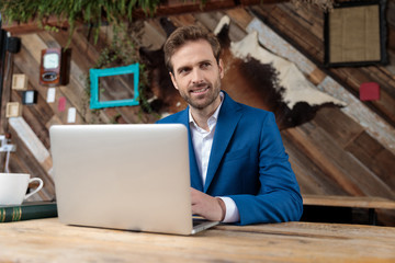 Cheerful businessman smiling and looking away