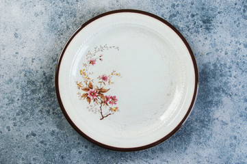 Antique porcelain plate on concrete