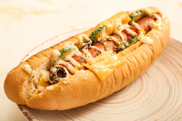 Plate with tasty hot dog on table, closeup