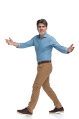 Side view of a positive casual man greeting