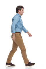 Side view of a motivated casual man stepping