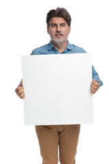 Smart casual man holding an empty billboard