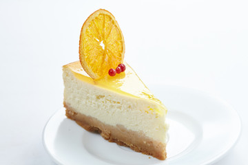 cheesecake with orange on the white plate