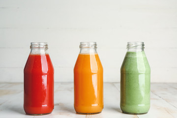 Bottles of fresh vegetable juices on table