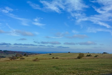 Fototapeta premium Green landscape with many blue sky in the Rhön, Bavaria, Germany