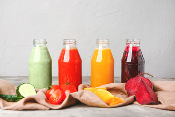 Bottles of fresh vegetable juices on table