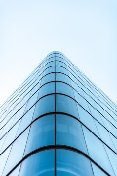 Panoramic and perspective wide angle view to steel light blue background of glass high rise building skyscraper commercial modern city of future. Business concept of successful industrial architecture