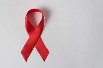Red ribbon on white background. Aid control symbol. Directly above