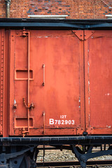 Fototapeta na wymiar Close-up of outer wall of old abandoned train wagon science industry museum manchester space for text warm colors colour rust wheel rails vintage antique