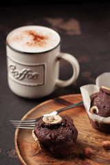 Tasty muffin with coffee on wooden plate. Colse-up.