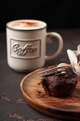 Tasty homemade muffin braking by fork. Tasty muffin with coffee close-up.