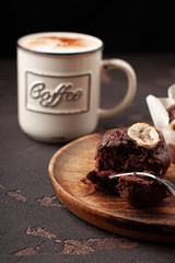 Tasty homemade muffin braking by fork. Tasty muffin with coffee close-up.