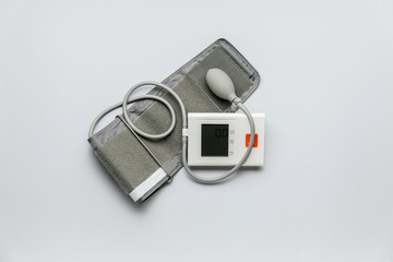 Electronic sphygmomanometer on light background