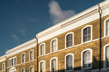 Nice windows or balconies an exclusive mews with white small houses in Chelsea, a wealthy borough...