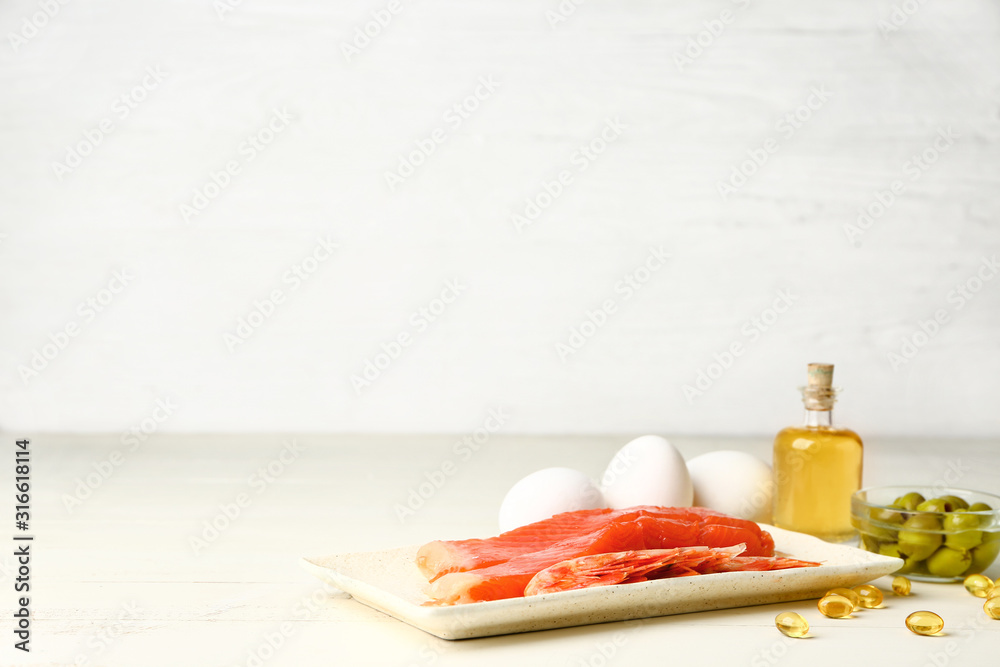 Wall mural Set of healthy products with high omega 3 and fish oil pills on white table