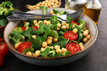 chickpea salad with ingredient and tomatoes and lamb´s lettuce. healthy salad