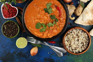 Chicken tikka masala spicy curry meat food in pot with rice and naan bread. indian food