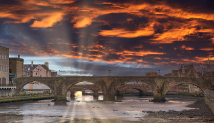 The Auld (Old) Brigg in Ayr in Scotland Dramatic Sunset over the Burn's Town