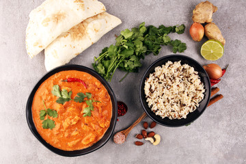 Chicken tikka masala spicy curry meat food in pot with rice and naan bread. indian food