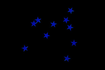scattering of sequins in the form of blue stars, isolate on a black background