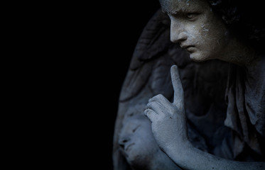 Religion and death concept. Ancient statue of an angel as symbol of end of life. Horizontal image.