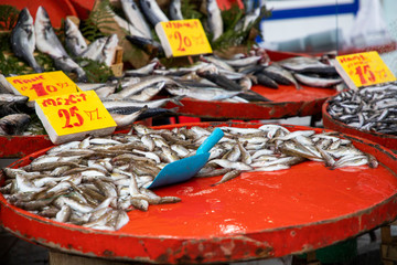 Fresh fish are sold at the market counter