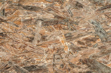 Surface texture of grunge weathered OSB oriented strand board closeup as background