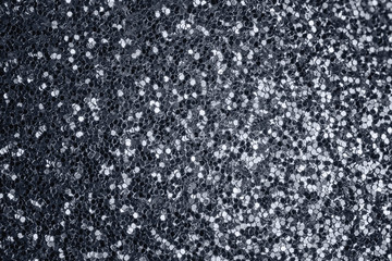 Gray shiny background from many small sparkles. Close-up, gray background for sites and layouts.