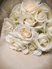 Bouquet of white roses on a leather chair