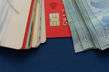 Credit card and cash on a blue background.