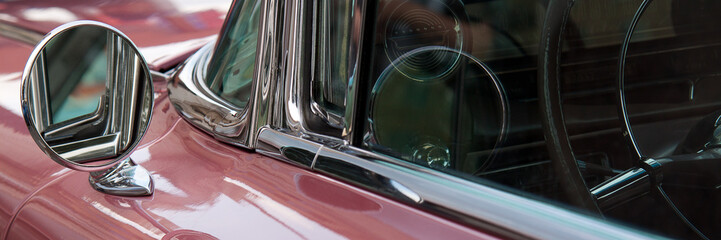 vintage pink car with a round mirror