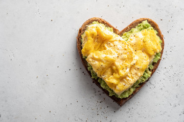 heart shaped healthy avocado toast with scrambled egg