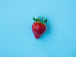Top view of strawberry on blue background