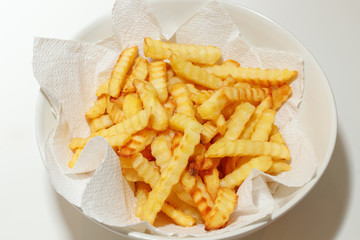 french fries on plate, on paper, white background