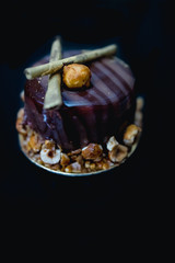 Luxury chocolate cake-cake decorated with a golden decor of caramelized popcorn on a dark background. Flat lay. Close-up. Copy space. - 316626787