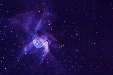 A blue nebula with many stars, and galaxies. Elements of this image were furnished by NASA
