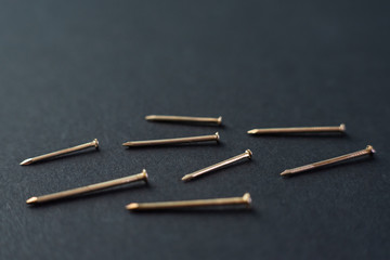 metal construction nails close-up on black background