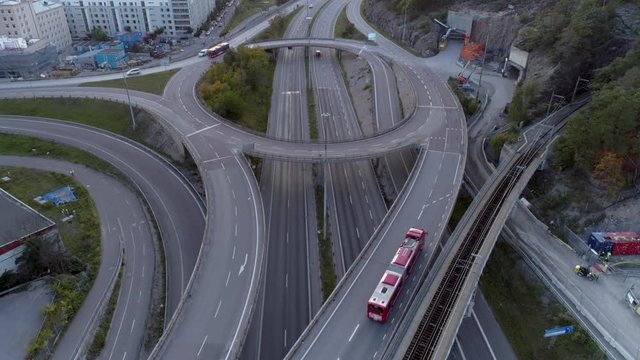 Aerial view of interchange elevated highway traffic. Drone shot flying over junction, cars and truck driving by. Urban transportation background in 4K resolution. Stockholm, Sweden