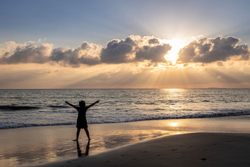 Latin woman with hat on the pacific beach sunset